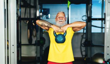 Hipster senior man training inside home gym