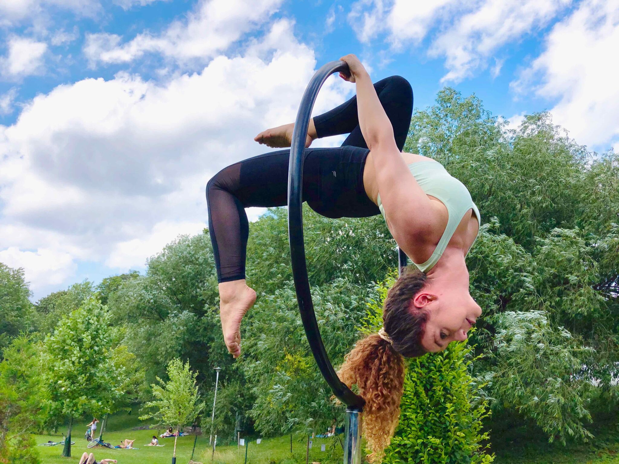 Cassandra wearing the V Shred Seamless Flex Sports Bra during an outdoor aerial hoop training session