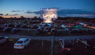 Photo of Golden Hour Festival cars lined up at the drive in watching a concert