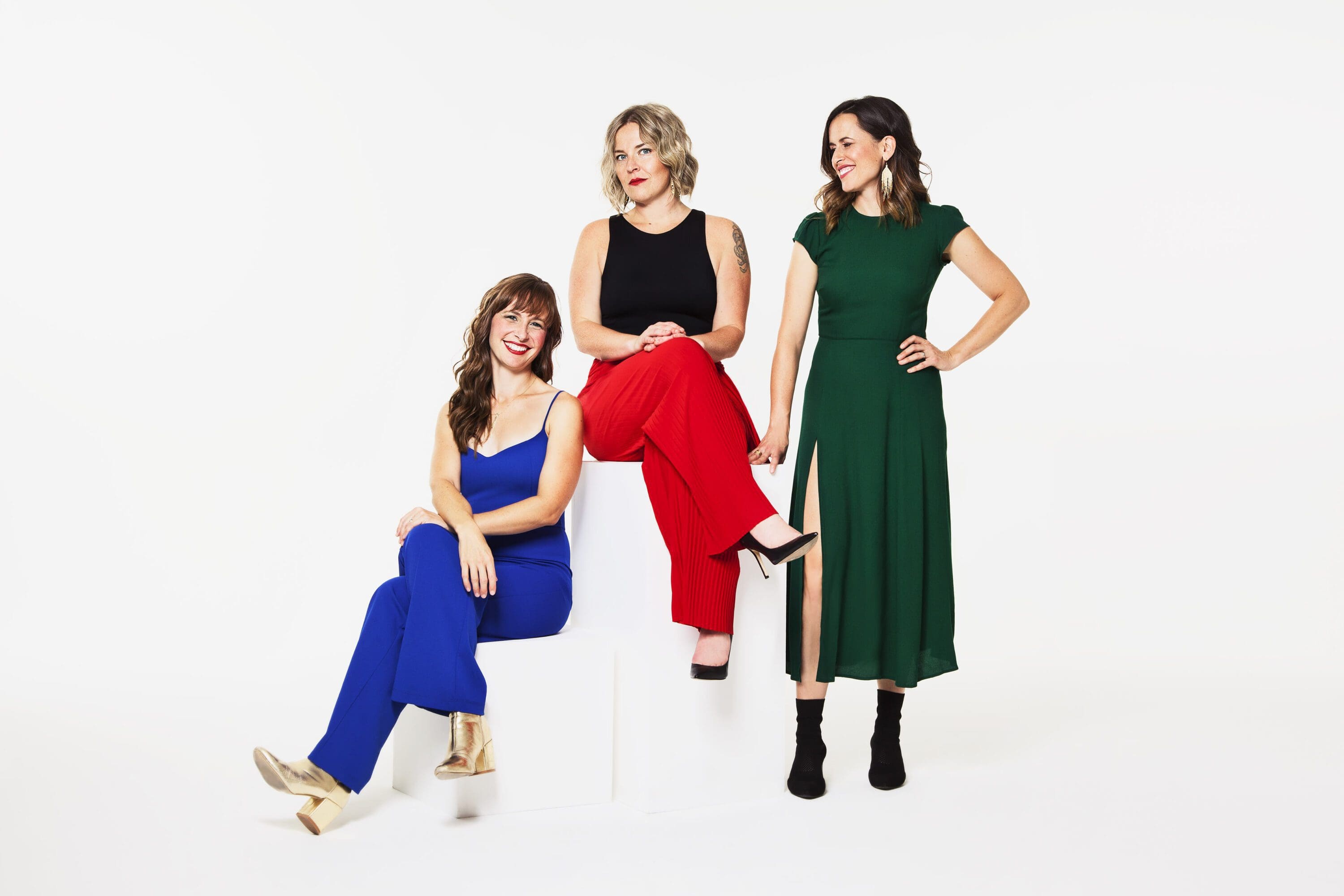 Good Lovelies promo photo. The band of 3 women are standing together and smiling.