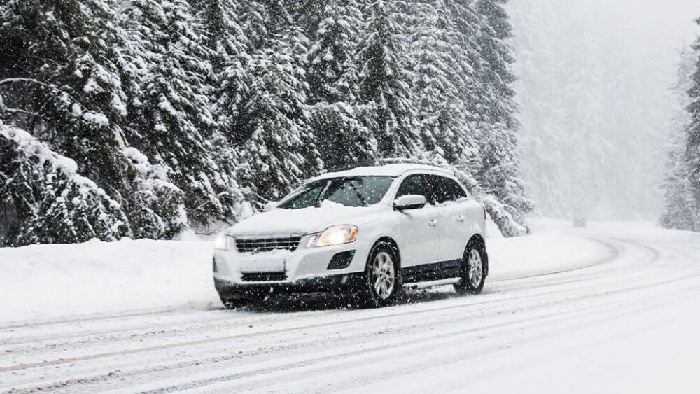 car driving on a snow covered road in winter